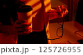 Closeup of Woman Holding Coffee Cup and Eyeglasses in Office. 125726955