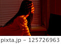 Focused Woman Working at Computer in Warm Office Light. 125726963