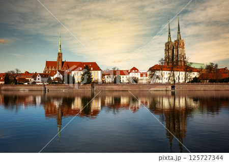 Stunning View Of Wroclaw's Historic City Center From The Oder River, A Popular Attraction In Poland at sunset Stunning View Of Wroclaw's Historic City Center From The Oder River, A Popular Attraction In Poland at sunset 125727344