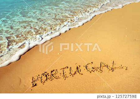 The inscription of Portugal on the beach of white sand 125727598