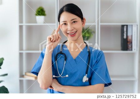 Asian female doctor or nurse standing confidently with stethoscope hanging on her neck Asian female doctor or nurse standing confidently with stethoscope hanging on her neck 125729752