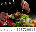A Culinary Moment: Red Wine Accompanies a Delectable Plate of Mixed Appetizers 125729918
