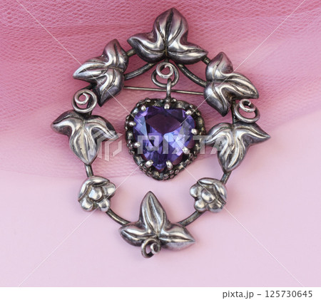 Handmade vintage brooch for women on soft background perfect for jewelry store marketing Handmade vintage brooch for women on soft background perfect for jewelry store marketing 125730645