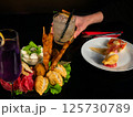 Cocktails and Appetizers on a Dark Table 125730789