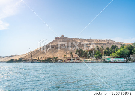 Feluccas Moored on Nile Riverbank near Aswan Dam, Egypt. Feluccas Moored on Nile Riverbank near Aswan Dam, Egypt. 125730972