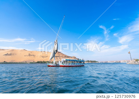 Tourist Felucca Sailing on Nile near Aswan, Egypt. Tourist Felucca Sailing on Nile near Aswan, Egypt. 125730976