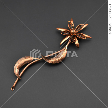 Retro brooch closeup on beige background for women Retro brooch closeup on beige background for women 125733321