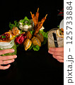 Sharing Cocktails and Appetizers black background 125733884