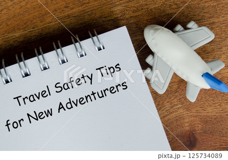Travel Safety Tips for New Adventures text on white notepad with toy airplane Travel Safety Tips for New Adventures text on white notepad with toy airplane 125734089