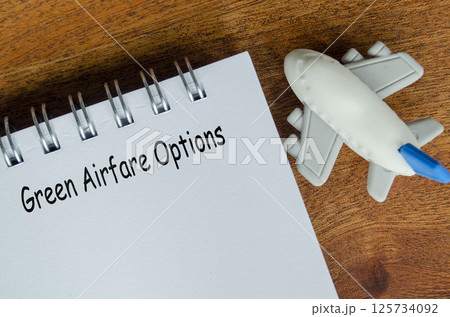 Green Airfare Options text on white notepad with toy airplane. Green Airfare Options text on white notepad with toy airplane. 125734092