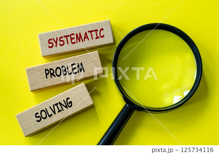 Top view of Systematic Problem Solving text on wooden blocks with magnifying glass. 125734116