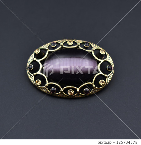 Vintage brooch floral detail closeup on soft background Vintage brooch floral detail closeup on soft background 125734378