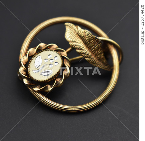 Retro brooch accessory for women displayed flat Retro brooch accessory for women displayed flat 125734420
