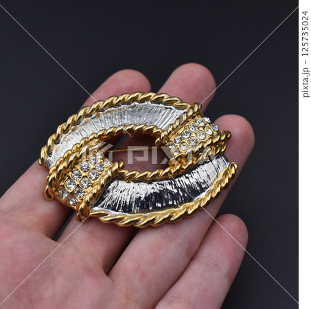 Retro floral brooch vintage handmade jewelry close up Retro floral brooch vintage handmade jewelry close up 125735024