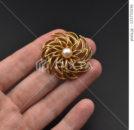 Fashion brooch floral vintage design laid on fabric Fashion brooch floral vintage design laid on fabric 125735036