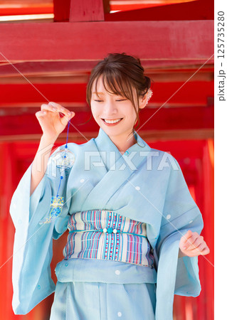 日本の夏・風鈴を持って鳥居に立つ浴衣姿の女性 日本の夏・風鈴を持って鳥居に立つ浴衣姿の女性 125735280