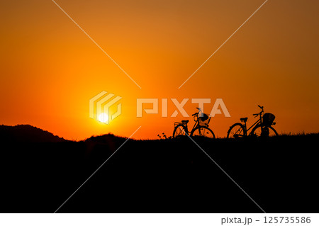 夕日と自転車のシルエット 125735586