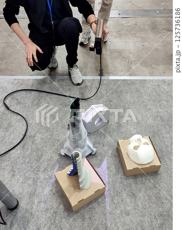 3D scanning. Working portable 3D scanner. Man scanning an object with a portable 3D scanner. Manual 3D scanning different models. New modern digitization technologies 3D scanning. Working portable 3D scanner. Man scanning an object with a portable 3D scanner. Manual 3D scanning different models. New modern digitization technologies 125736186