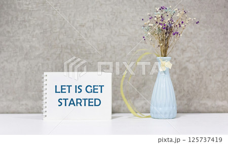 LET'S START writing the concept of the text in a notebook on a beautiful background 125737419