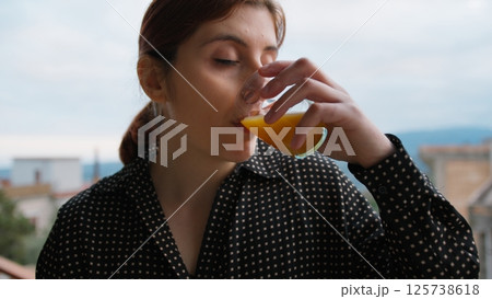 Italian Woman Drinks Orange Carrot Juice To Take Vitamins In The Morning Italian Woman Drinks Orange Carrot Juice To Take Vitamins In The Morning 125738618