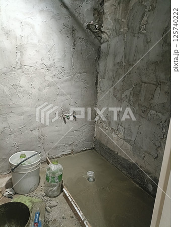 A wet cement in renovated bathroom creates rough texture little stressful for new construction project A wet cement in renovated bathroom creates rough texture little stressful for new construction project 125740222
