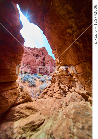 Desert Sandstone Formations Through Natural Arch Midday Sunburst Perspective 125742006