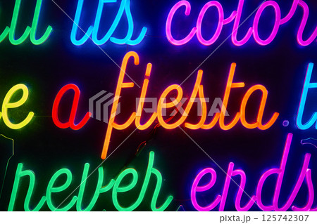 Vibrant Neon Fiesta Sign Urban Nightlife Eye-Level Perspective Vibrant Neon Fiesta Sign Urban Nightlife Eye-Level Perspective 125742307