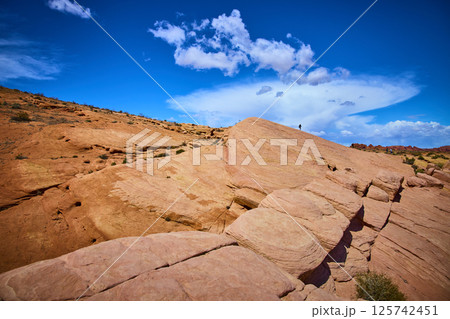 Majestic Sandstone Formations with Lone Explorer Low Angle View Majestic Sandstone Formations with Lone Explorer Low Angle View 125742451