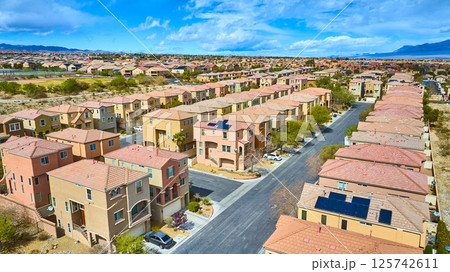 Aerial of Suburban Desert Community with Solar Panels and Mountains Aerial of Suburban Desert Community with Solar Panels and Mountains 125742611