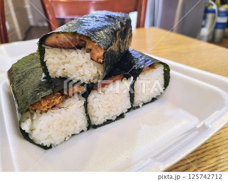 Stacked Musubi with Rice and Seaweed Close-up in Casual Dining Setting Stacked Musubi with Rice and Seaweed Close-up in Casual Dining Setting 125742712