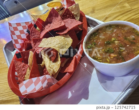 Colorful Tortilla Chips with Salsa in Casual Dining Eye-Level View 125742715