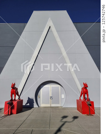 Geometric Facade with Red Dog Statues in Urban Setting Eye Level View 125742746