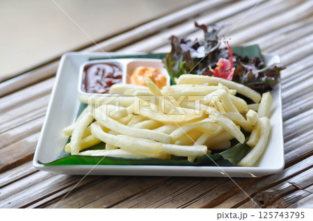 French fries or fried potato , fries with keychup and cheese dip French fries or fried potato , fries with keychup and cheese dip 125743795