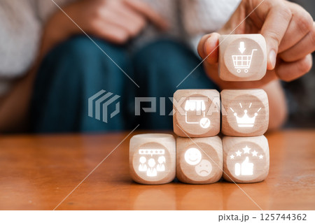 Wooden blocks with icons representing the net promoter score concept, highlighting customer satisfaction and feedback. 125744362