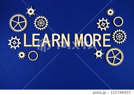 Learn More alphabet letters with gears element on navy blue background Learn More alphabet letters with gears element on navy blue background 125746955