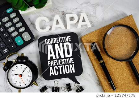 CAPA - Corrective and Preventive Action acronym with calculator, alarm clock and magnifying glass, business concept background CAPA - Corrective and Preventive Action acronym with calculator, alarm clock and magnifying glass, business concept background 125747579
