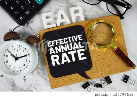 EAR - Effective Annual Rate acronym with calculator, alarm clock and magnifying glass, Business and Financial concept background EAR - Effective Annual Rate acronym with calculator, alarm clock and magnifying glass, Business and Financial concept background 125747612
