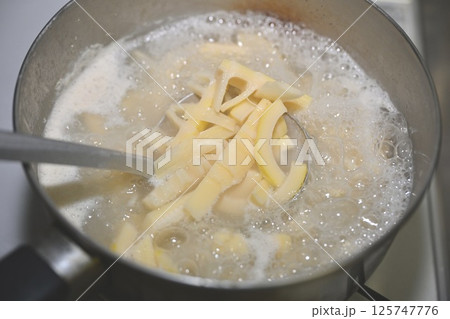 生の筍（たけのこ、タケノコ、竹の子）を、鍋で米の研ぎ汁で下茹でする。 125747776