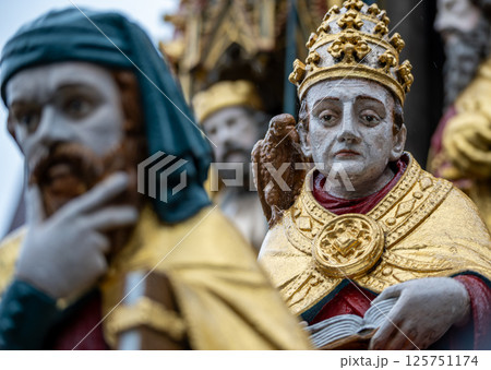 Nuremberg, Germany, August 2, 2023. Detail of one of the many statues that characterize the golden fountain in the market square. Travel destinations and tourist attractions. Nuremberg, Germany, August 2, 2023. Detail of one of the many statues that characterize the golden fountain in the market square. Travel destinations and tourist attractions. 125751174