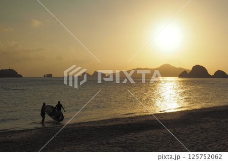 座間味島、カヌーを漕ぐ人　夕景の海 125752062