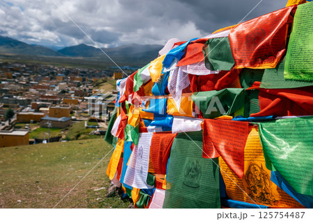 The Changqing Chunker Temple  in Litang, China. Many colourful prayer flags on the mountain top beside the temple.Spirituality and meditation. 125754487