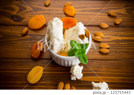 Healthy cottage cheese dessert with nuts and dried fruits 125755443