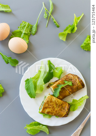Healthy egg roll with greens on a white plate 125755464