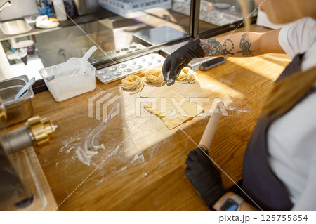 The Baking Process Rolling Dough with Great Precision and Care in the Kitchen is Essential 125755854