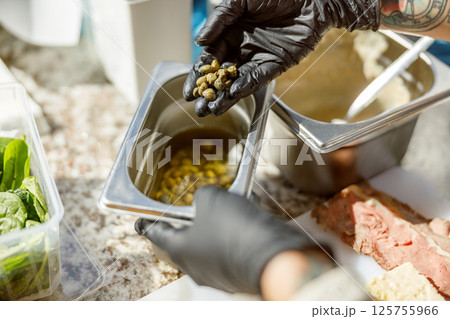 Carefully preparing gourmet ingredients with precision and attention to detail is essential 125755966