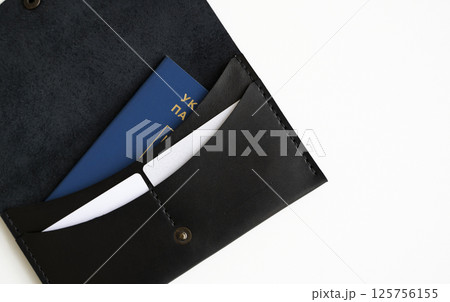 Black Leather Wallet with Passport and Cards on White Background 125756155