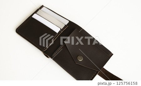 Open handmade leather wallet with card slots and coin pocket on white background Open handmade leather wallet with card slots and coin pocket on white background 125756158