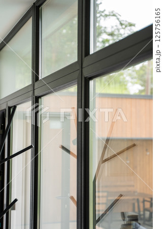 Angled view of modern window frame with clean aluminum junction and outdoor blur Angled view of modern window frame with clean aluminum junction and outdoor blur 125756165