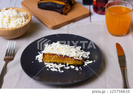Baked plantains with white cheese Baked plantains with white cheese 125756610