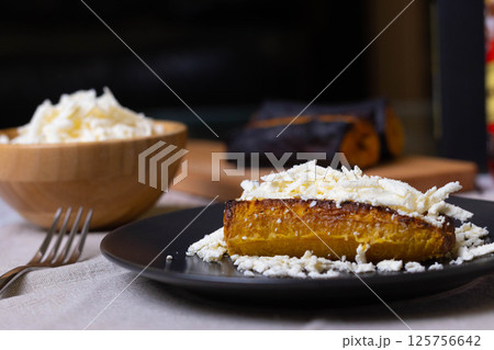 Baked plantains with white cheese Baked plantains with white cheese 125756642